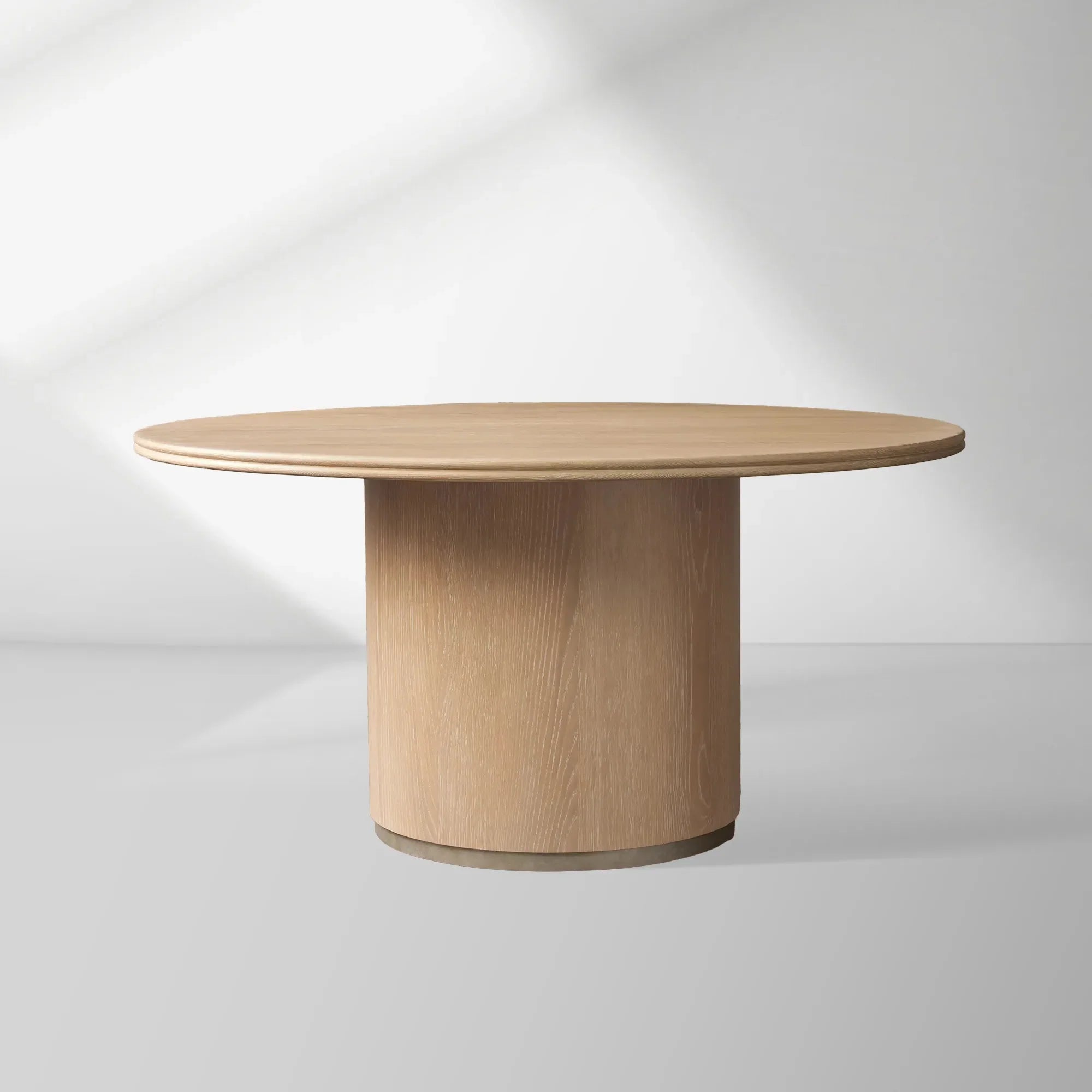 2000x2000_20260120_HL_b1.jpg Caden Round Dining Table with Wooden Top Sculptural Base & Antiqued Metal Plinth - Image 1